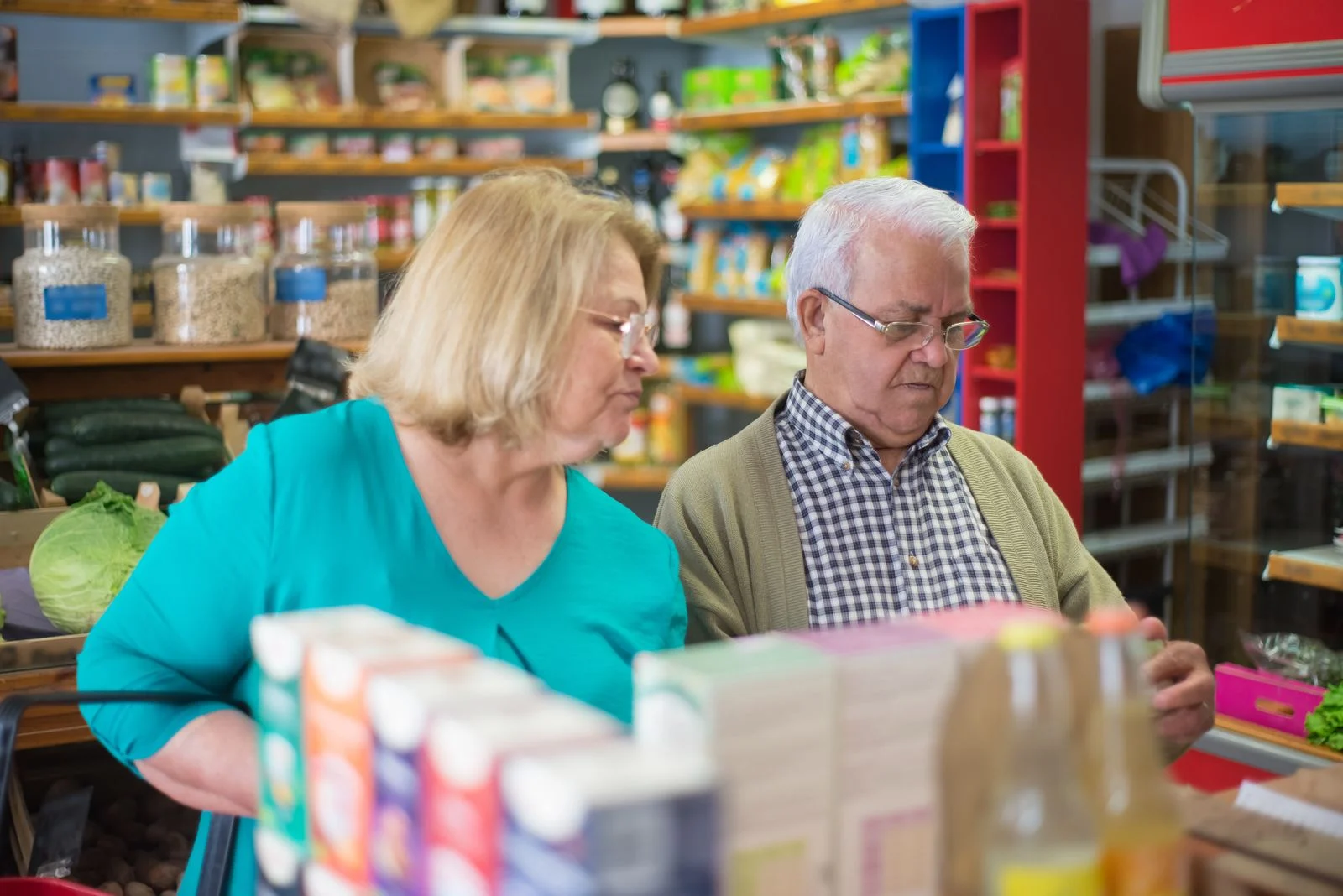An older couple shopping for groceries together.