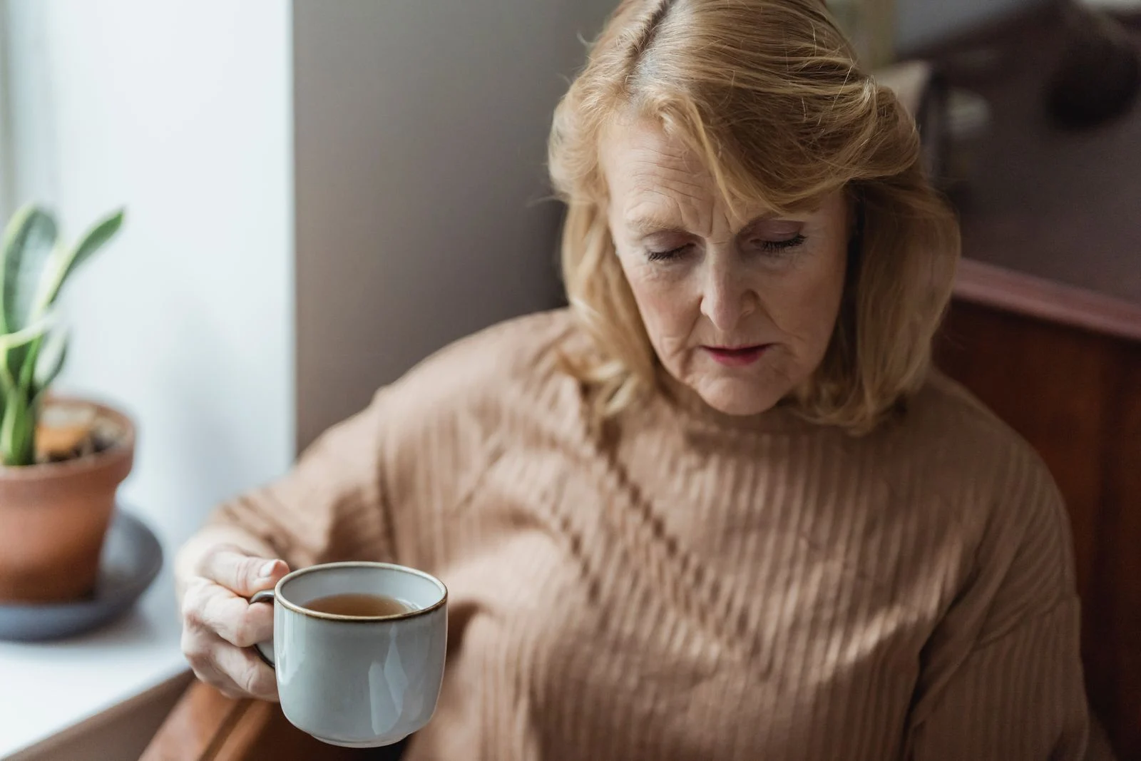 A woman taking a quiet break with a cup of tea.