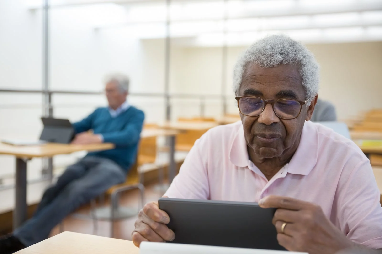 An older man using a tablet.