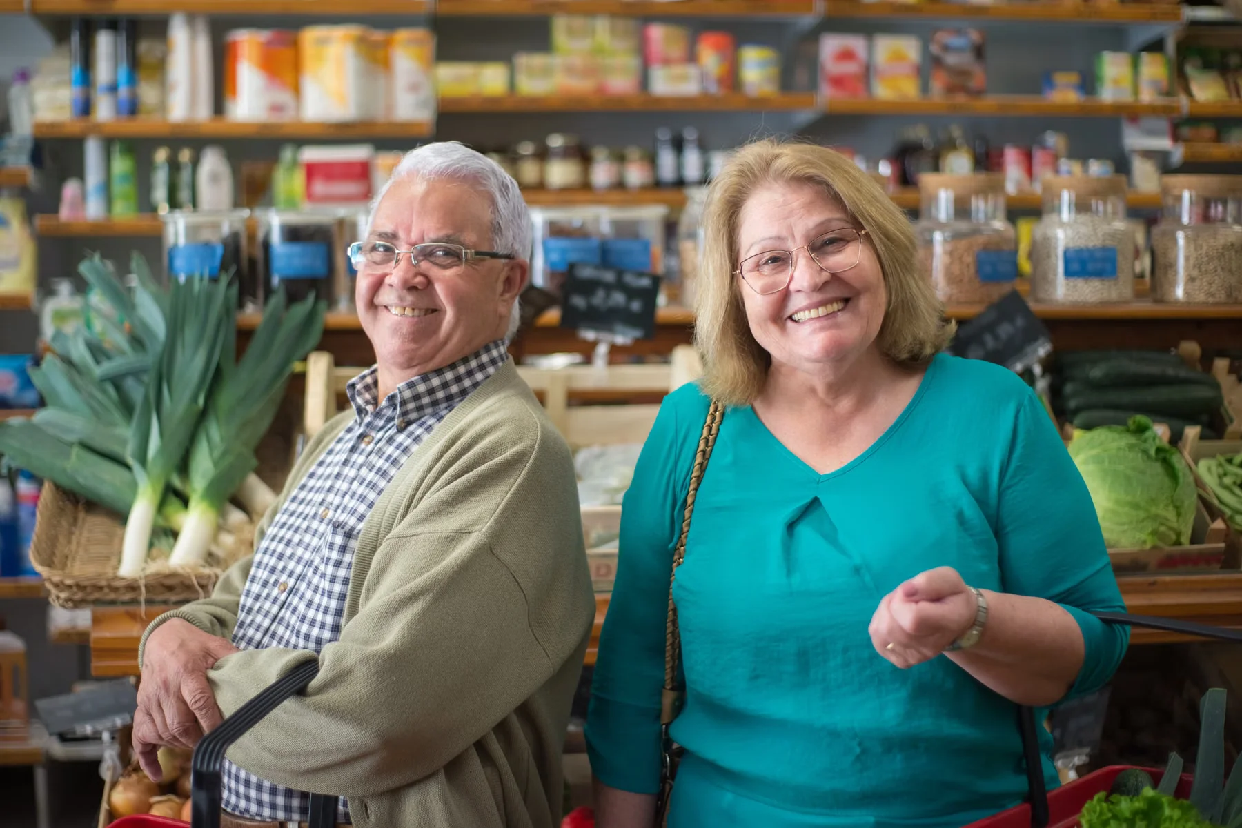 An older couple shopping for groceries together.